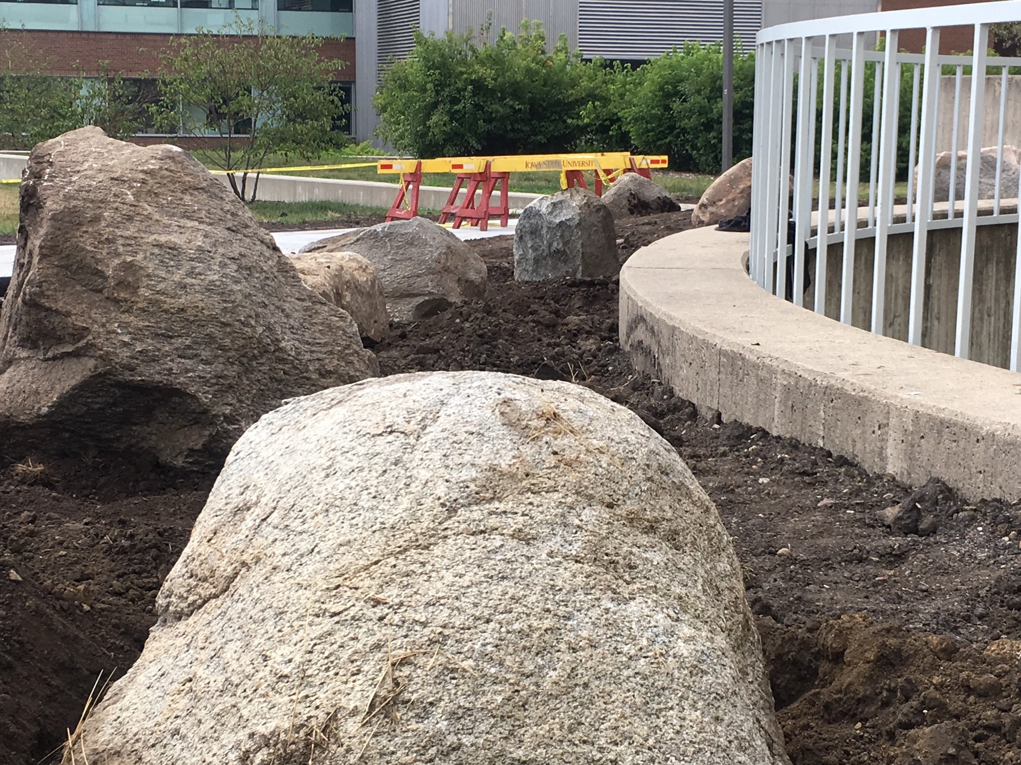Fifteen large field boulders were placed throughout the new entrance plaza to serve as informal seating and provide visual interest. Eight boulders are arranged in a curve around the circular opening for the staircase.
