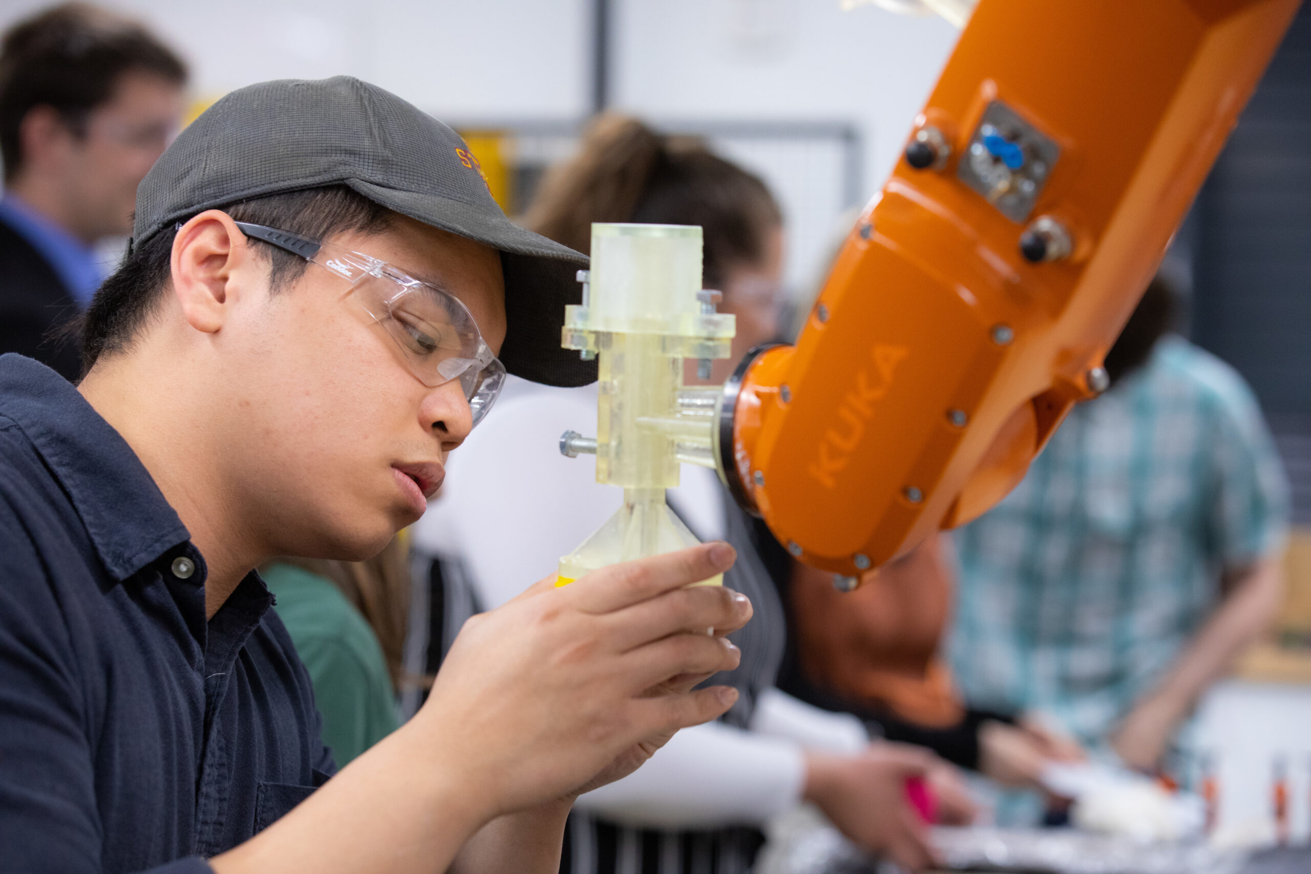 Student learning how to work with a robotic arm.