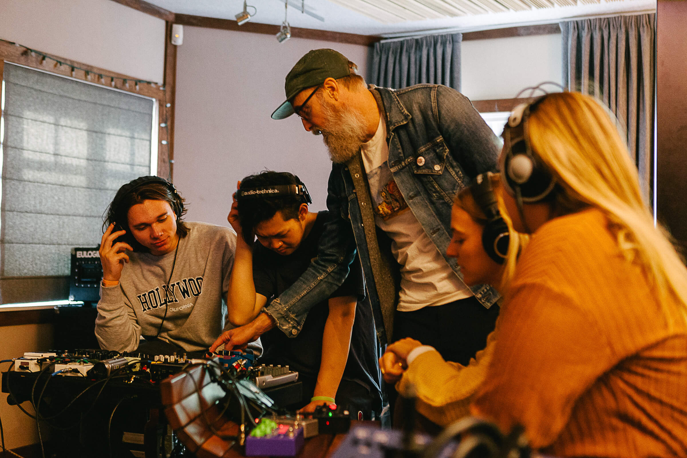 Graphic design students learning audio equipment and mixing in AK Studio class with Alex Braidwood in Los Angeles.