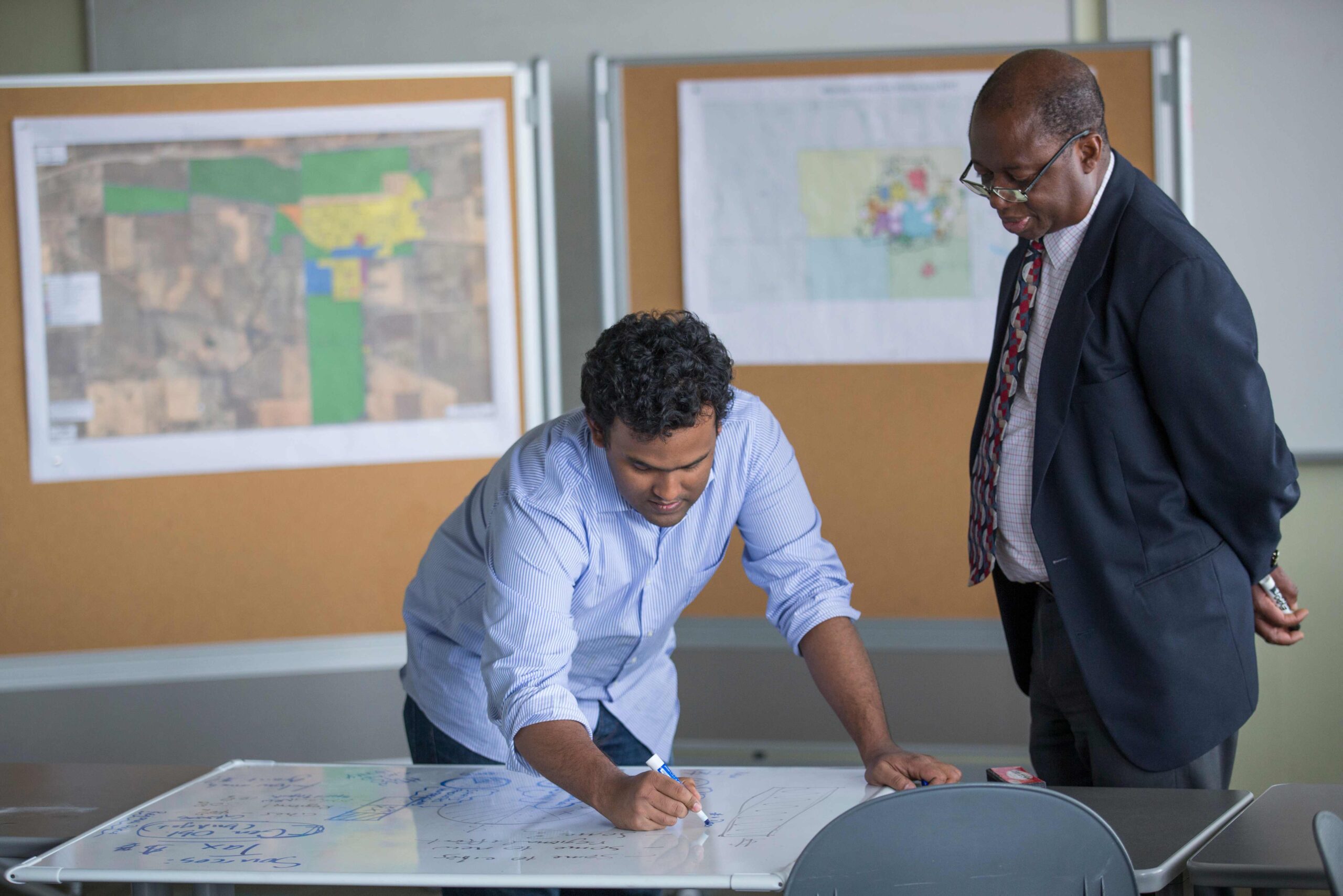 A College of Design professor and student working on whiteboard