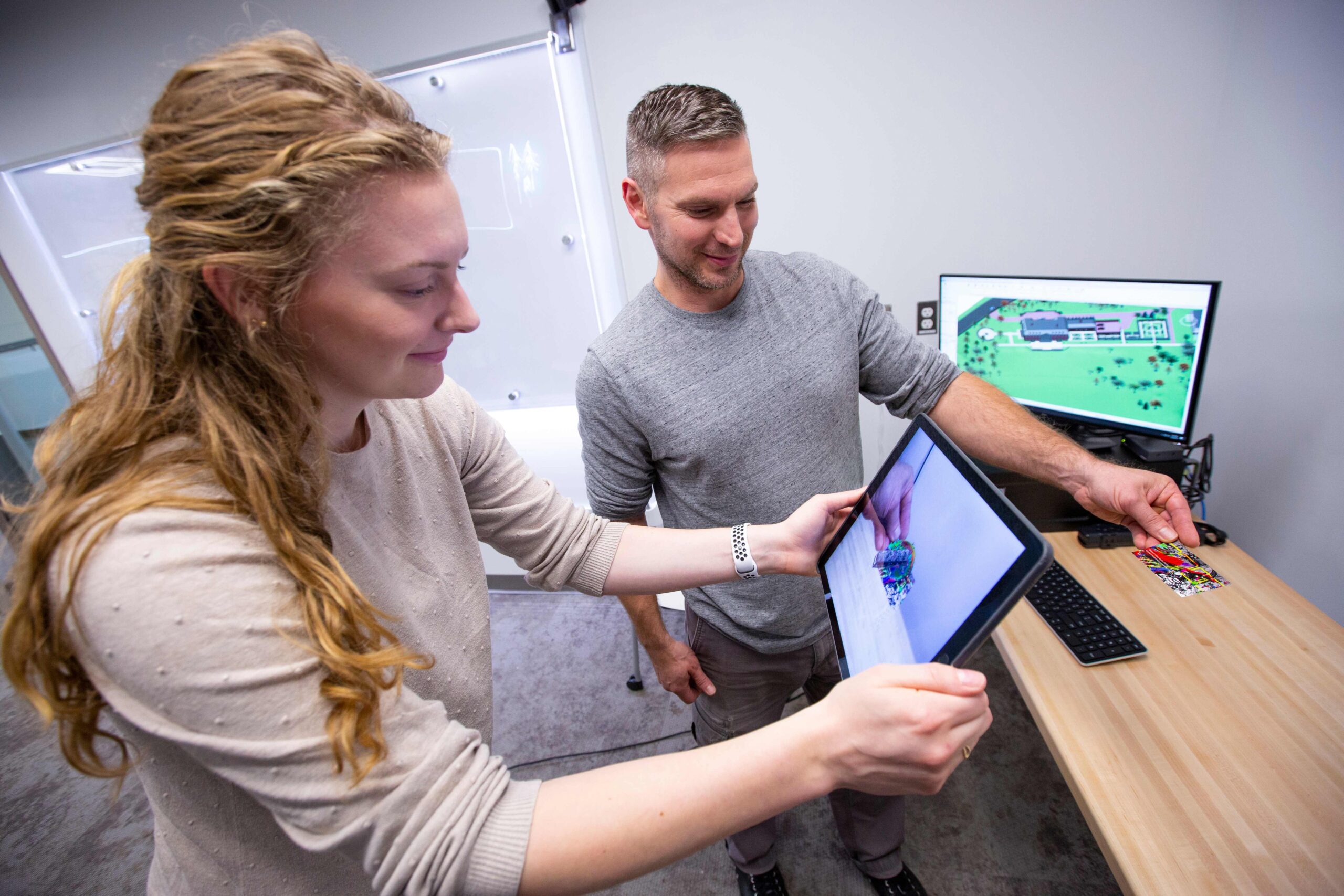 A student and professor work with 3D model for augmented reality.