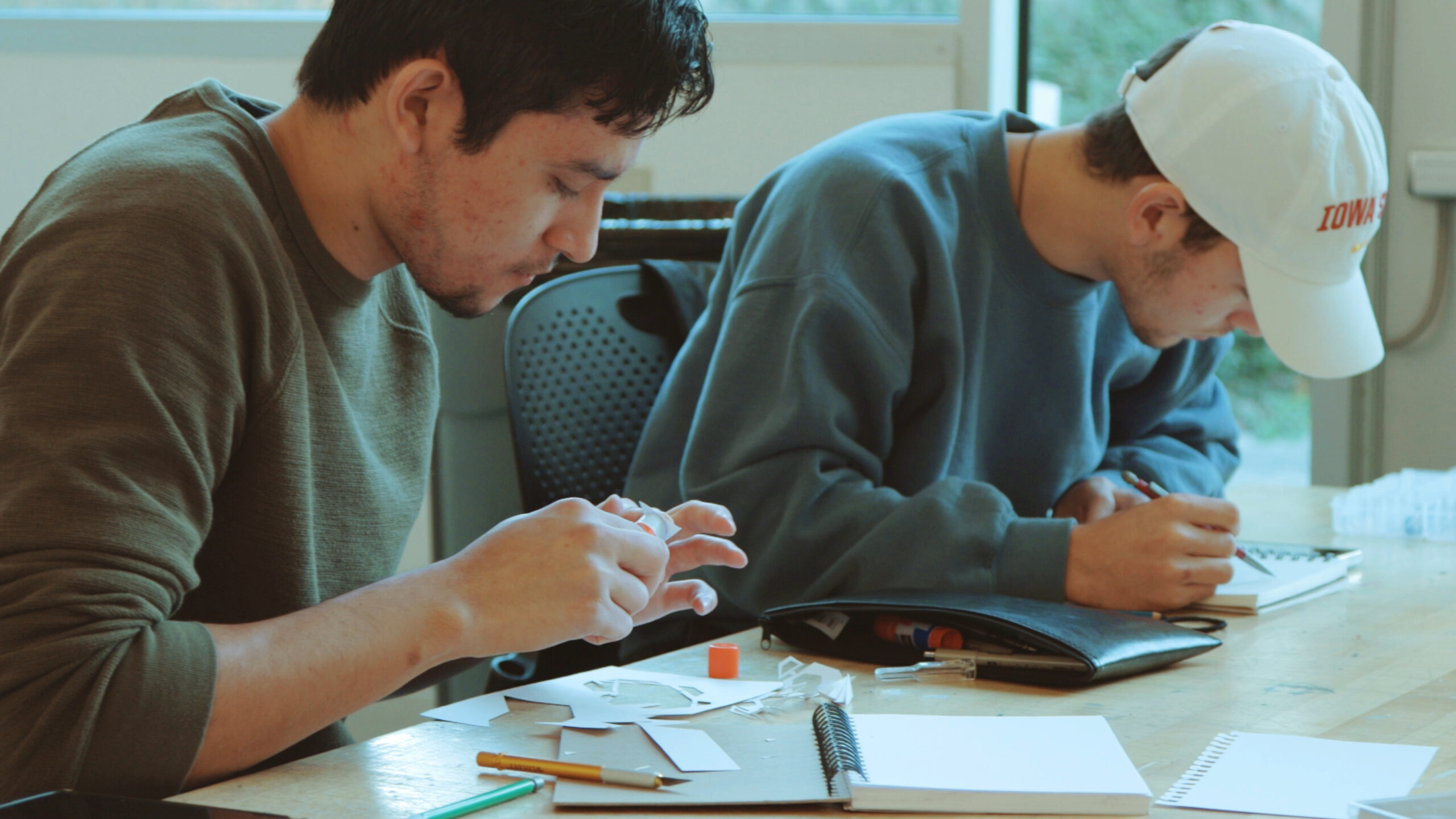 Two male students working on Wearables project for Design 102 class.