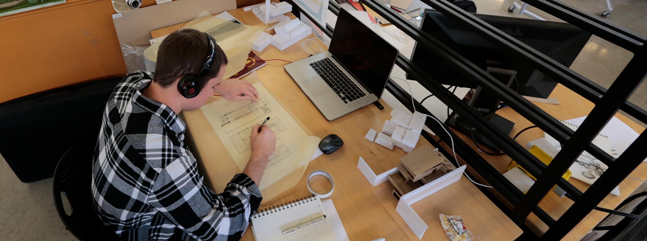 Interior design student working at desk.