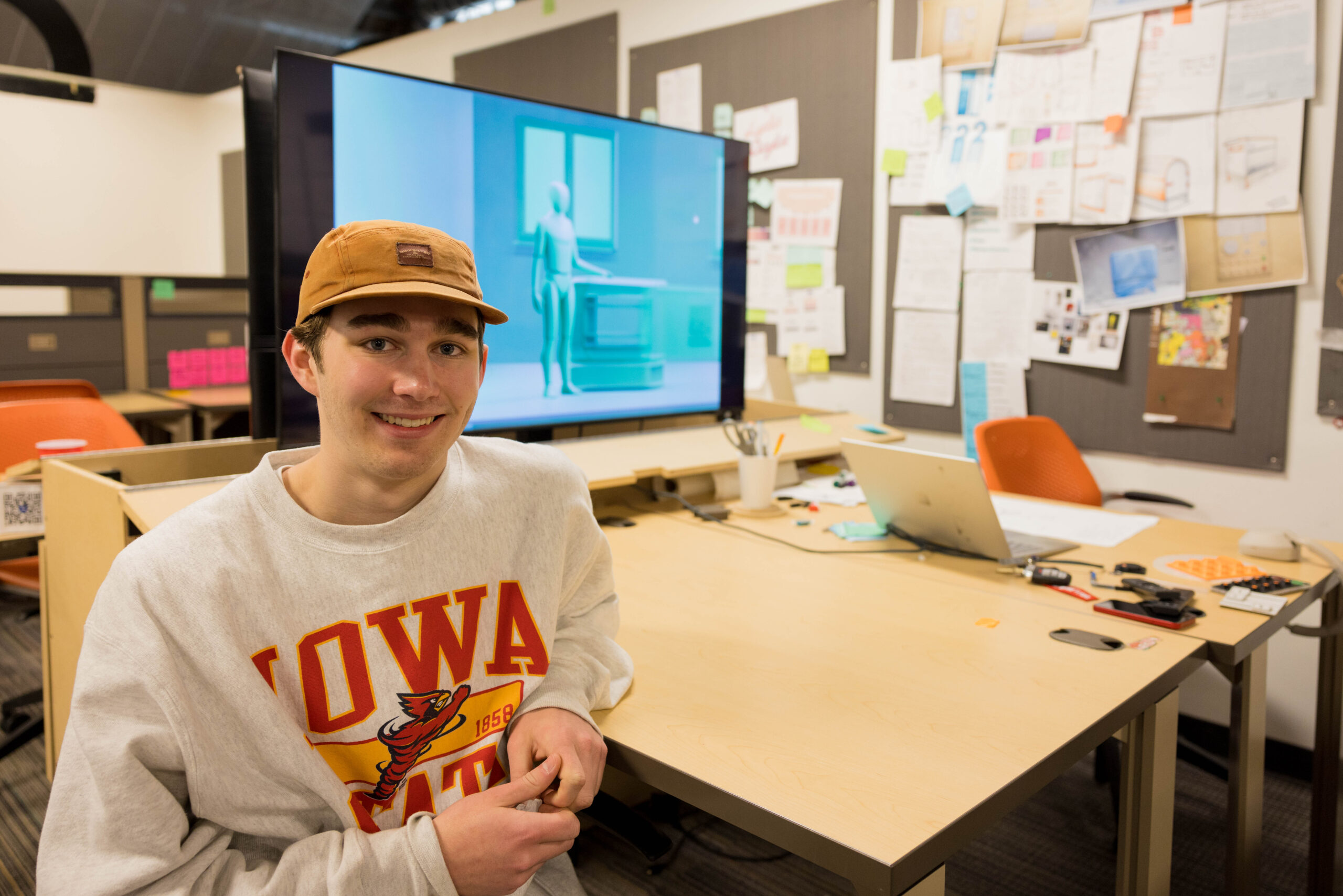 Luke Chaney sits at his desk in the College of Design's Armory facility.